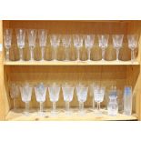 Two shelves of assorted crystal and glass table items, including Lenox crystal stemware in the "