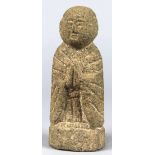 Japanese stone Jizo Bosatsu, Buddhist protector of children and travellers, standing and praying,