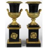 Pair of Neoclassical style urns, with brass mounts and rising on a square plinth, 14"h x 5"w x 5"d