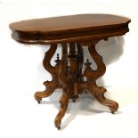 Victorian Eastlake occasional table, having a shaped top over a carved apron and rising on a