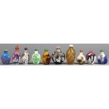 (lot of 10) Group of Chinese overlay glass snuff bottles, six featuring figures; one of pink peach