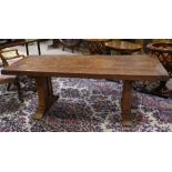 Provincial style farmhouse dining table, the rectangular plank top resting above the trestle