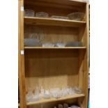 Three shelves of pressed glass table items, possibly by Fostoria, consisting of plates, largest 10"