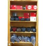 Four shelves of assorted camera cases and boxes, including both hard and soft sided Leica cases