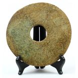 Chinese hardstone bi-disc, the plain disc of mottled brown and sea-green hue, 8.5"w
