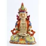 Chinese enameled porcelain bodhisattva, the benevolent face framed by a diadem, in dhyana asana