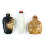 (lot of 3) Chinese stone snuff bottles: one of mottled black and tan ground; another a plain