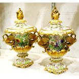 Pair of Continental porcelain potpourri jars, having a gilded scrolled leaf finial over the urn form