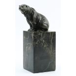 Patinated bronze figural sculpture of a bear, depicted seated, gazing outward and rising on a marble
