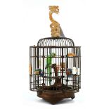 Chinese bird cage, of floral form with dragon form wooden hook, interior having five porcelain