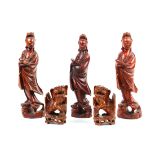 (lot of 5) Chinese wood carvings: consisting of a pair of fu-lions; together with three female