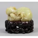 Chinese jade carving, featuring three recumbent rams nestled together, with wood stand, 3"w;