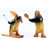 Polyte Solet wood carved penguins, one depicting a skiier, and one depicting a badmitton player,