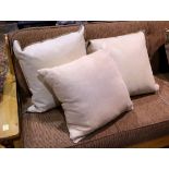 (lot of 5) Suede and leather throw pillows, executed in off-white, (2) with embossed decoration