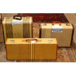 (lot of 3) Mid-Century Modern suitcases, each executed in striped canvas, and bearing a Blue Star