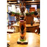 Bill Kuhnley totem pole, having polychrome decoration in green and red, with mother of pearl