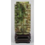 Chinese hardstone carving, of cong form executed from mottled dark green matrix, with wood stand,