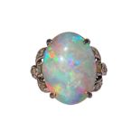 Opal, diamond and 10k white gold ring Centering (1) oval opal cabochon, measuring approximately 19 X