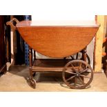 Georgian style mahogany tea cart, having a drop leaf top, and rising on a wheeled base, 29"h x 37"