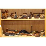 Two shelves of assorted antique wood working tools, comprising a various smoothing planes;