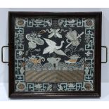 Chinese rank badge set into a tray, embroidered with a crane amid Daoist treasures on a blue ground,
