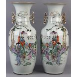 Pair of Chinese enameled porcelain vases, each with a trumpet neck flanked by shaped handles,
