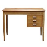 Mid-Century Modern desk, having a rectangular top, above three drawers, and rising on a tapered