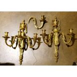 Louis XVI style gilt bronze wall mount light fixtures, each with three S-form arms suporting