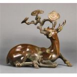 Chinese bronze sculpture of a deer, the recumbent animal clasping a large lingzhi sprig in its