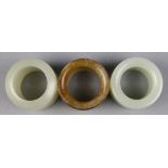 (lot of 3) Chinese hardstone archer's rings, each with thick walls, including one with a canted