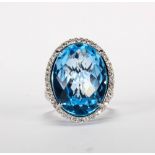 Blue topaz, diamond and 14k white gold ring Featuring (1) oval faceted top blue topaz, weighing