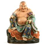 Chinese enameled porcelain Budai, seated in royal ease holding a ruyi scepter and a strand of prayer