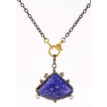 Tanzanite, diamond and silver pendant-necklace Featuring (1) carved tanzanite, measuring