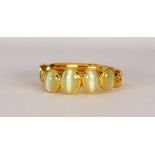 Cat's eye chrysoberyl and 18k yellow gold ring Featuring (4) oval cat's eye chrysoberyl cabochons,