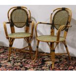 (Lot of 2) French bistro rattan armchairs, each having a balloon back, accented with black and