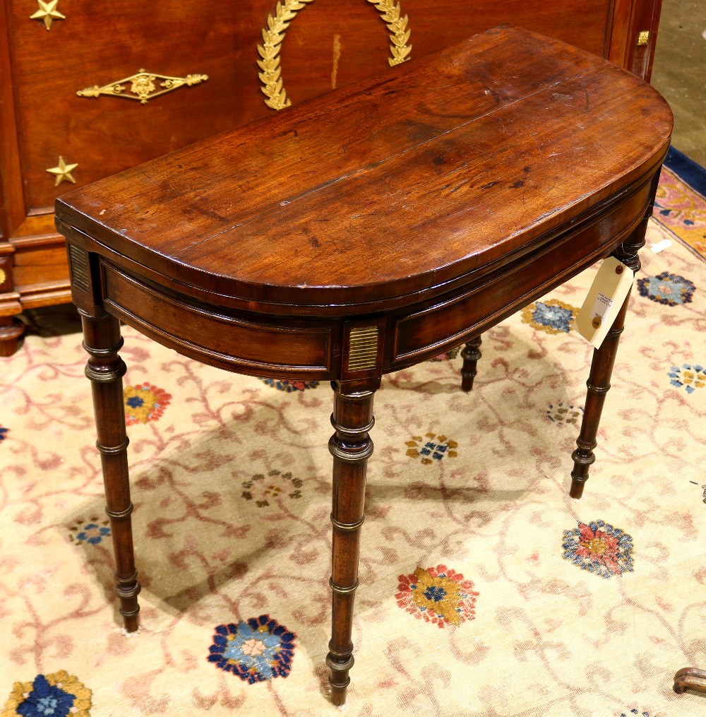 Federal mahogany demi-lune games table, having a flip top and rising on turned legs, 29"h x 36"w x