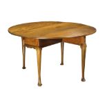 Queen Anne drop leaf table, having an oval top, and rising on cabriole legs terminating on pad feet,