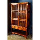 Chinese wooden kitchen cabinet, with railed hinged double doors and side panels, above a row of