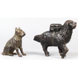 (lot of 2) Cast iron dog penny/still banks, consisting of one depicting a working dog with a