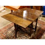 Georgian gate leg table, executed in oak, having rectangular drops and rising on turned legs, 28.5"h