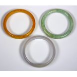 (Lot of 3) Jade bangles Including 1) carved jadeite bangle, measuring approximately 12.75 mm, widest