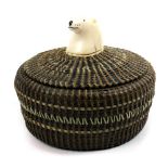 Eskimo baleen basket by Andrew Oenga, having a polar bear finial above the baleen body with a