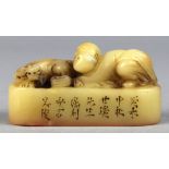 Chinese soapstone seal, the tan colored matrix carved with a child nestled beside a mythical