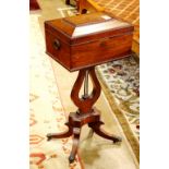 English Regency mahogany tea poy, having a casket form case accented with gadrooned carving, opening