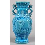 Chinese turquoise glaze porcelain vase, the shaped neck flanked by dragon handles, above the body
