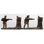 (lot of 2) Cast iron mechanical penny banks, comprising one depicting a soldier attired in a red