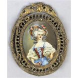 Rococo style miniature framed portrait, the oval gilt metal frame adorned with a foliate and foliage