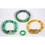 (Lot of 4) Jadeite jewelry Including 1) jadeite bangle, carved in relief with a ruyi design,
