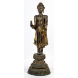 Thai bronze standing Buddha, with both hands in abhaya mudra, standing on a tiered lotus pedestal,