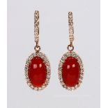 Pair of coral, diamond and 14k rose gold earrings Featuring (2) oval coral cabochons, measuring